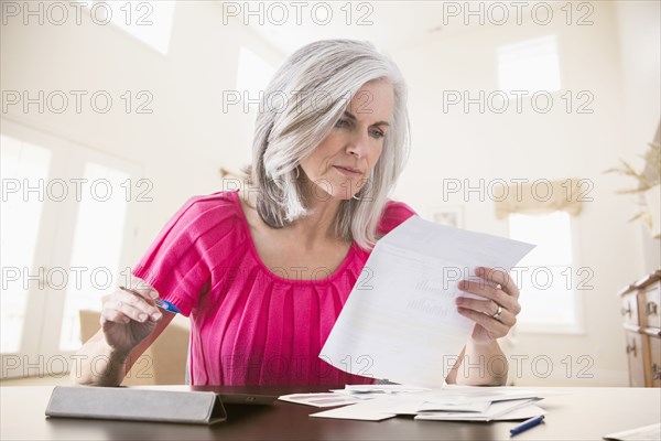 Caucasian woman paying bills online