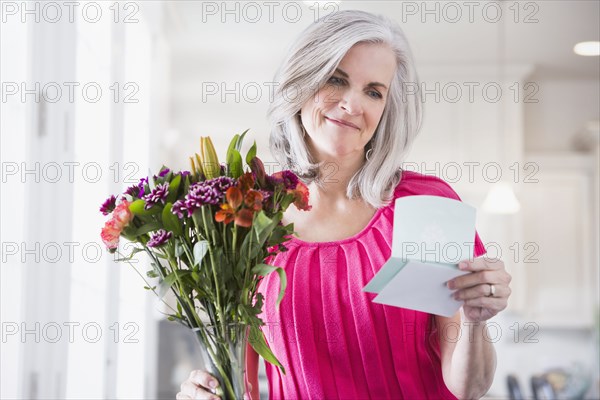 Caucasian woman receiving bouquet of flowers