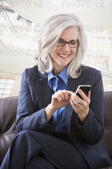 Caucasian businesswoman text messaging