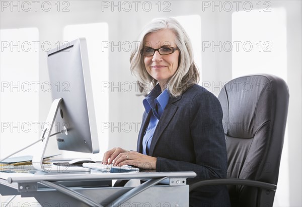 Portrait of confident Caucasian working at computer