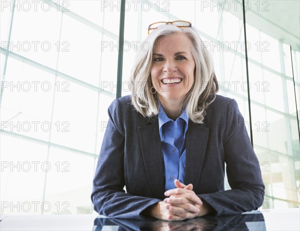 Portrait of confident Caucasian businesswoman at desk
