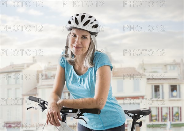 Portrait of confident Caucasian woman on bicycle
