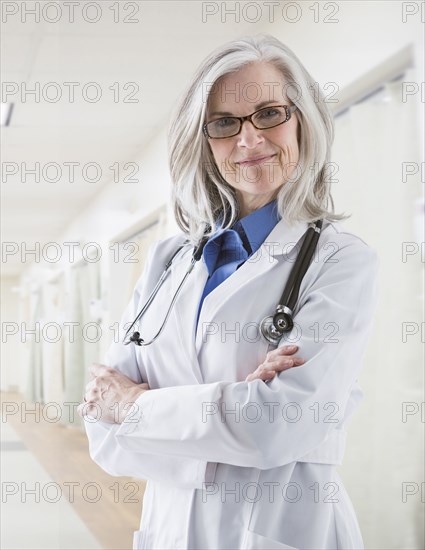 Portrait of confident Caucasian doctor in corridor