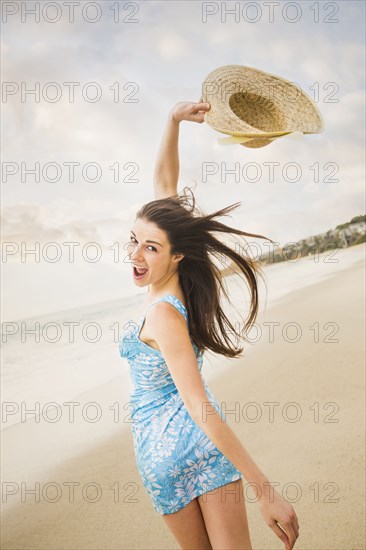 Caucasian woman playing on beach