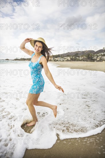 Caucasian woman playing on beach