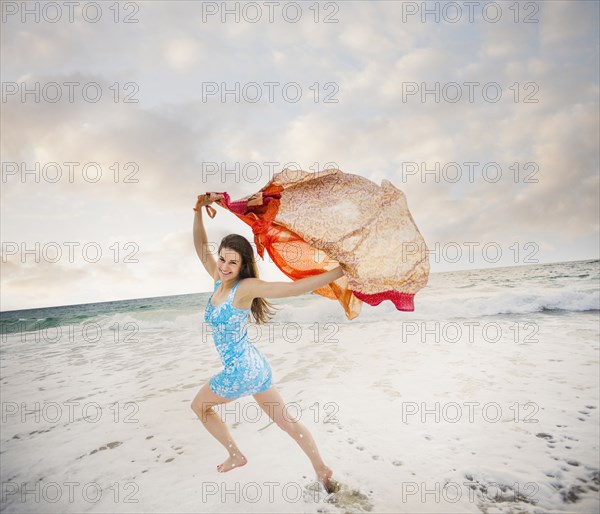 Caucasian woman playing on beach