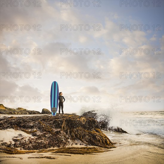 Caucasian surfer with board on beach