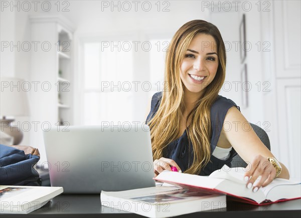 Mixed race woman studying at home