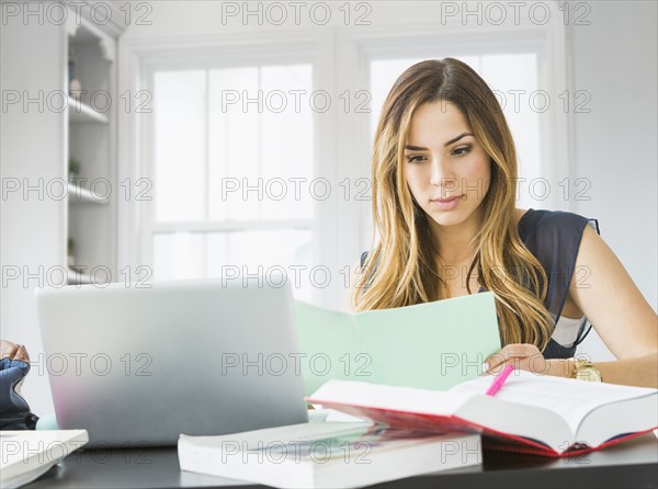 Mixed race woman studying at home