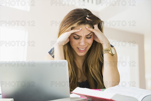 Mixed race woman studying at home