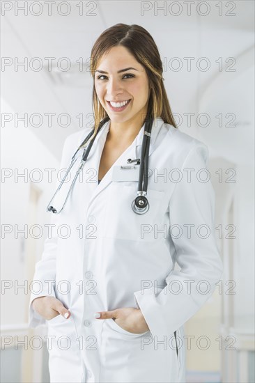 Mixed race doctor smiling in hospital