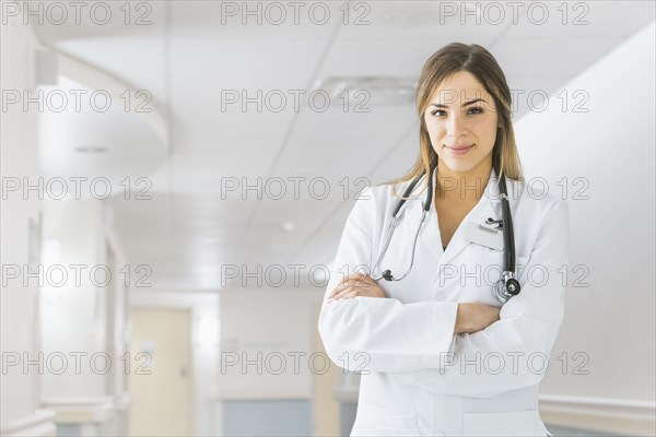 Mixed race doctor smiling in hospital