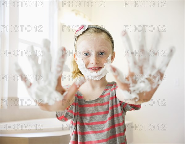 Caucasian girl playing with shaving cream