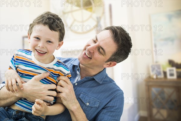 Caucasian father and son playing together