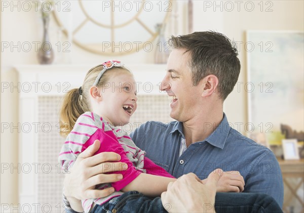 Caucasian father and daughter playing together