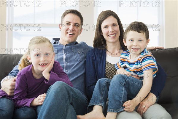 Caucasian family relaxing on sofa