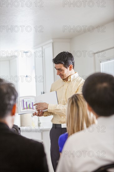 Businessman giving presentation to colleagues