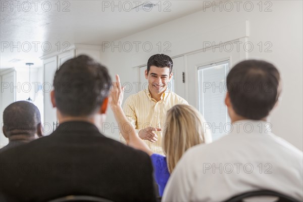 Businesswoman raising her hand in presentation