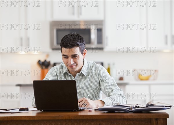 Hispanic businessman working at home