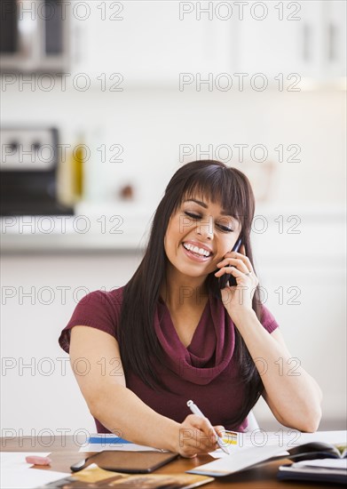 Hispanic businesswoman working at home