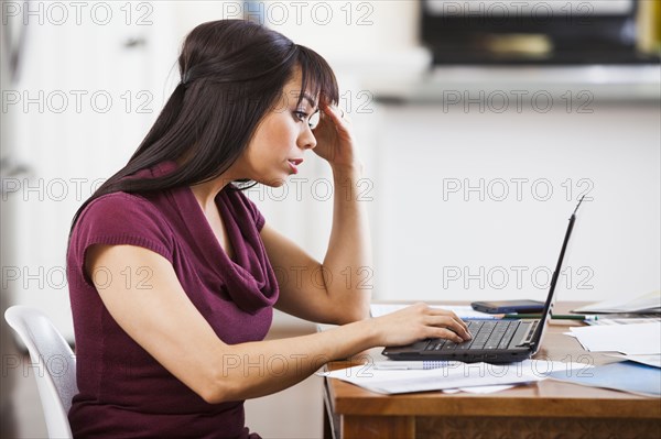 Hispanic businesswoman working at home