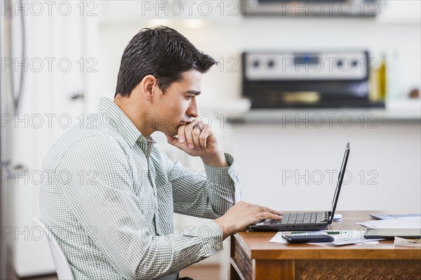 Hispanic businessman working at home