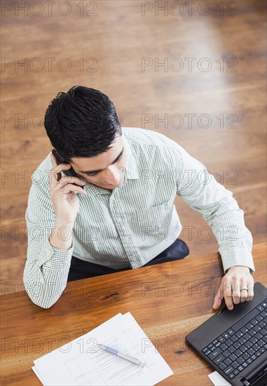 Hispanic businessman working at desk