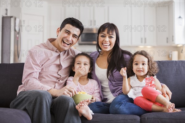 Family smiling together on sofa