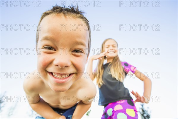 Low angle view of Caucasian children smiling outdoors