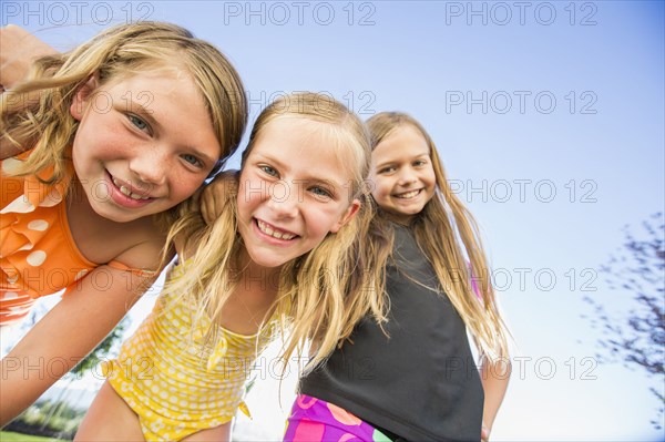 Low angle view of Caucasian girls smiling outdoors