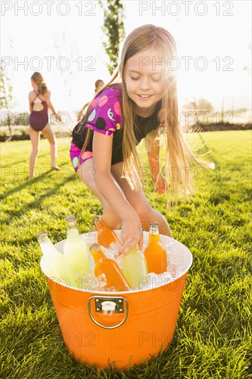 Caucasian girl drinking soda in backyard