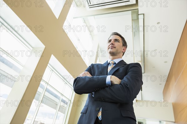 Low angle view of Caucasian businessman standing in office