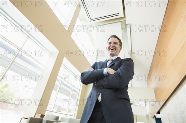 Low angle view of Caucasian businessman standing in office