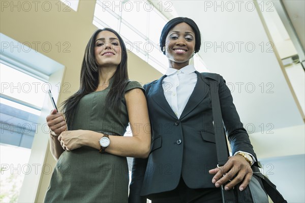 Low angle view of businesswomen smiling in office