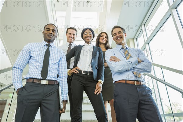 Low angle view of business people smiling on office staircase