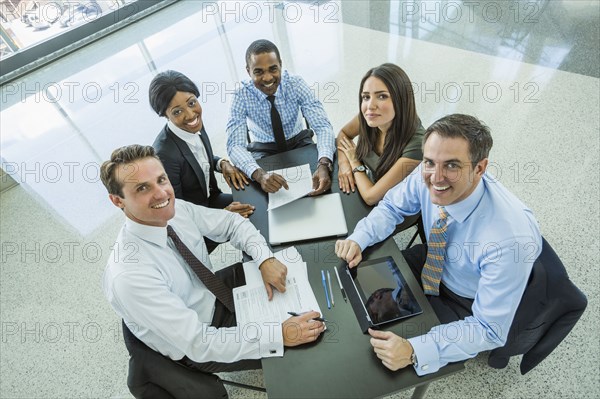 High angle view of business people smiling in meeting