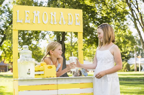 Caucasian girl buying drink at lemonade stand