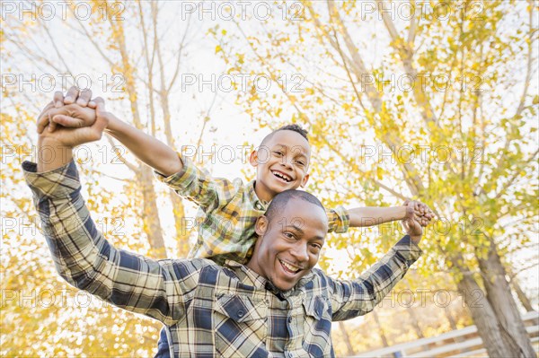 Father carrying son outdoors