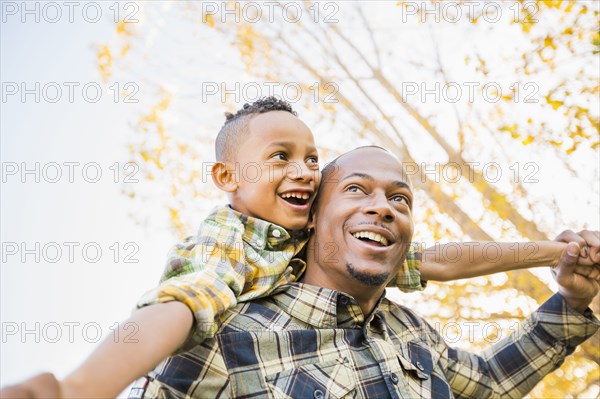 Father carrying son outdoors