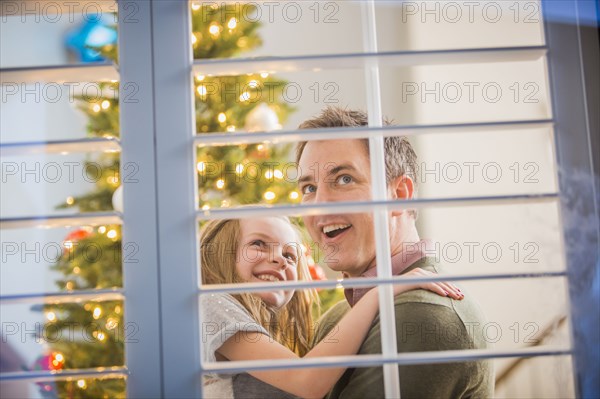 Caucasian father and daughter looking for Santa at Christmas