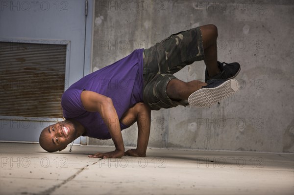 Black dancer balancing on hands