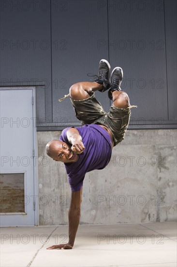 Black dancer balancing on hand