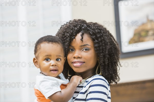 Close up of Black mother holding baby son