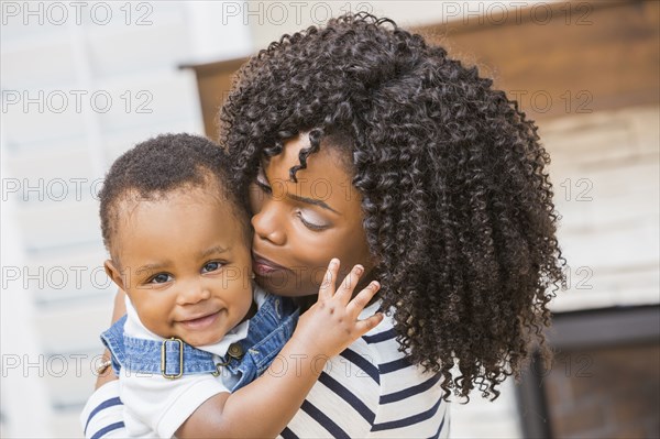 Close up of Black mother holding baby son