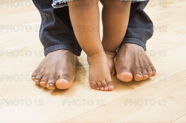 Close up of feet of Black father and baby son