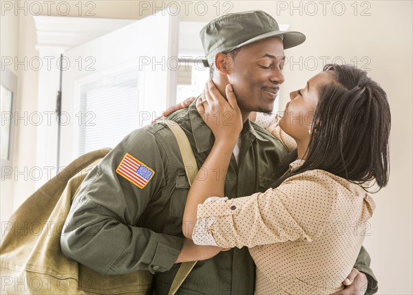 Close up of woman kissing returning soldier