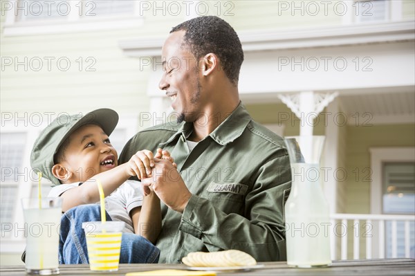 Father and son relaxing in backyard