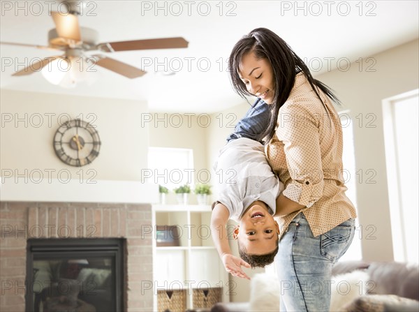 Mixed race mother and son playing in living room