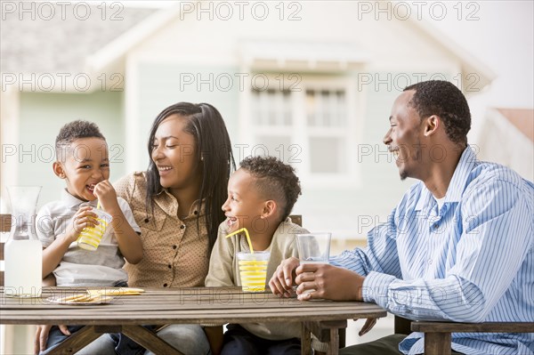 Family drinking juice in backyard