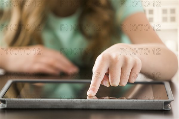 Close up of Caucasian girl using digital tablet